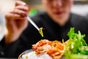 chef decorated plate with food on kitchen