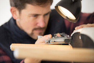 young repairman stapling a chair