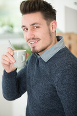 handsome young man holding a cup of coffee