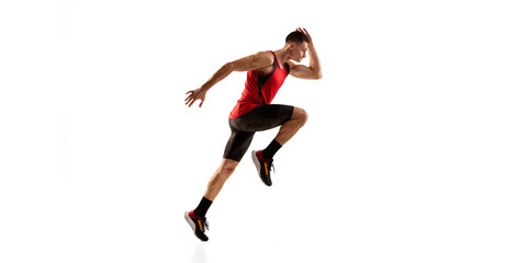 Sportive man, muscular athlete, runner wearing bicycle shorts in motion and action isolated over white background. Energy, speed, sport and beauty concept