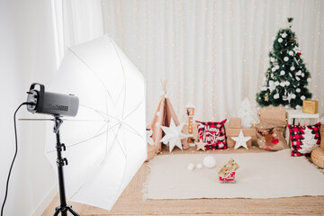 close up of photography studio set up of christmas decoration. star, lights, christmas tree, gifts and ornaments
