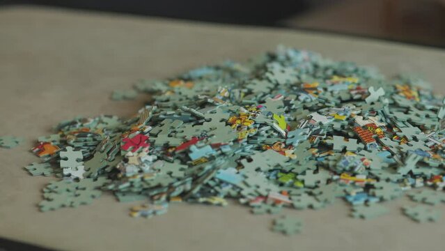 Tipping out jigsaw puzzle pieces to start anew