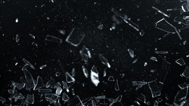 Super Slow Motion Shot of Glass Shards Flying Towards Camera Isolated on Black at 1000fps.