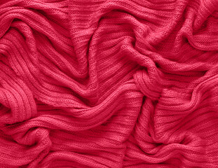 Texture of smooth knitted sweater with pattern. Handmade knitting wool or cotton fabric texture. Background of Large knit pattern with knitting needle or crochet. Color Of The Year 2023 - Viva Magenta