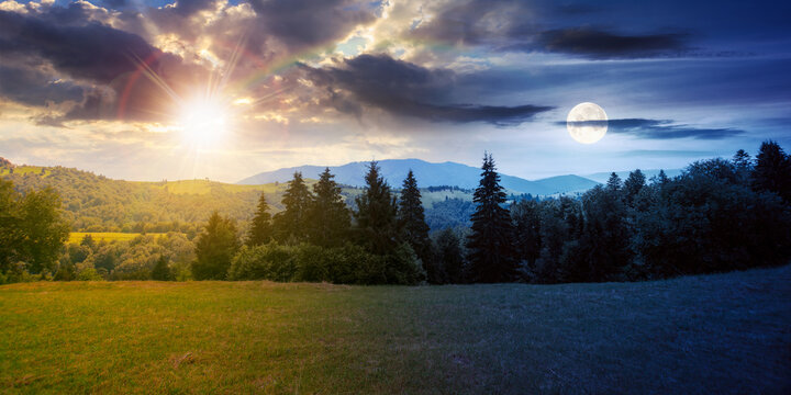 countryside landscape at twilight in summer. day and night time change concept. forested hills and grassy meadows in mountains. fluffy clouds with sun and moon on the gorgeous sky