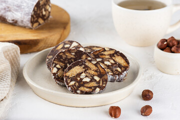 Russian breakfast chocolate sausage salami without sugar, gluten and lactose with cup of tea.