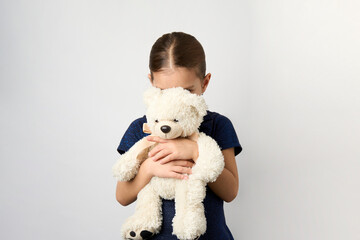 Portrait of little girl with white toy bear
