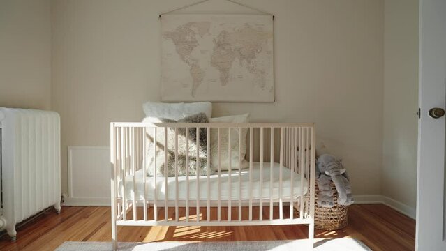 push in shot of a baby crib within the nursery of a home