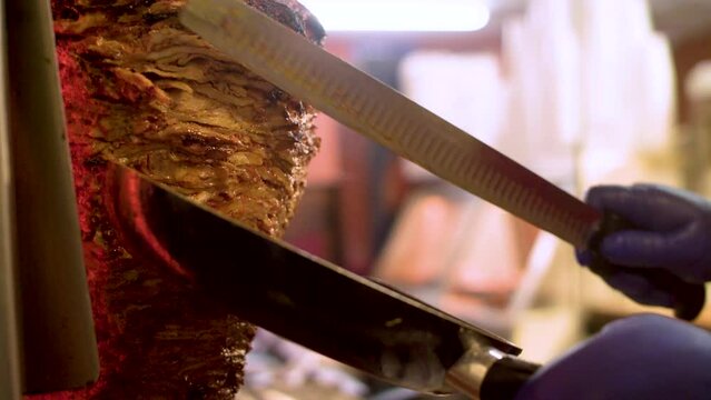 Shawarma Meat is Cut Into Pan With Knife
