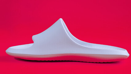 Women's rubber home slippers white color isolated on magenta background