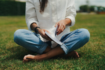 Girl Reading and Walking on Grass, Phone
