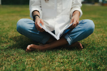 Girl Reading and Walking on Grass, Phone
