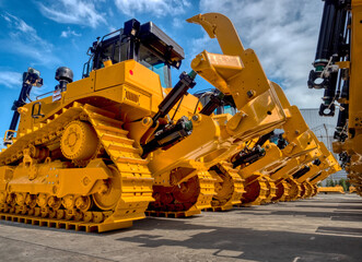 The new bulldozers are parking in factory 's yard before export.