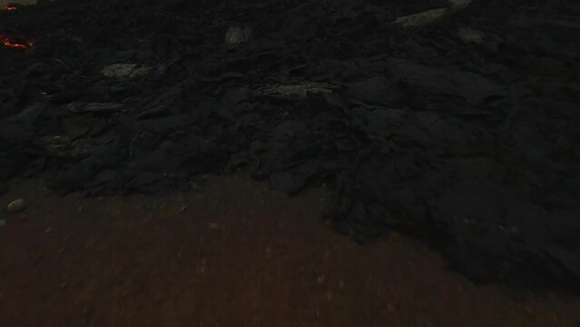 Fpv drone shot flying over the river flow and around an erupting Volcano crater