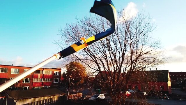 Close-up, Slow Motion 30FPS, Proudly Flying the Swedish Flag on Apartment House