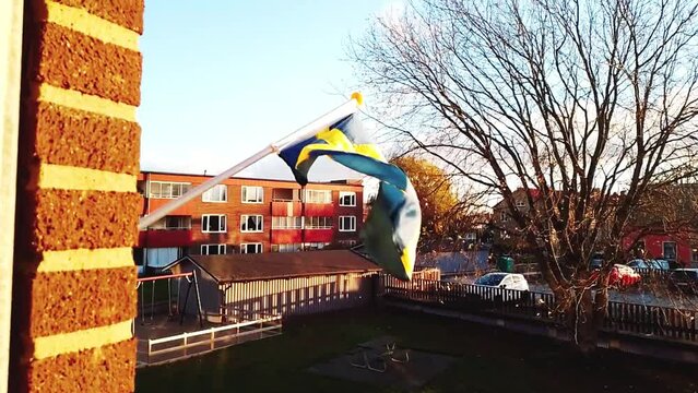 Slow Motion 30FPS Proudly Flying the Swedish Flag on Suburban Apartment House