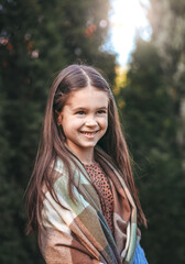 Portrait of a young beautiful brunette little girl outdoor in summer day.  Closeup portrait of a beautiful swarthy baby with perfect skin and dark hair. 