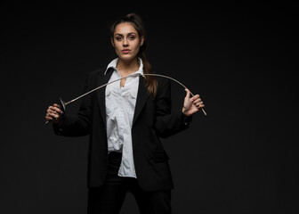 portrait of a young woman in a dark suit with a rapier and a mask.expressive portrait of a...