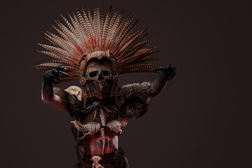 Shot of creepy zombie woman dressed in dark aboriginal attire and ceremonial headdress.