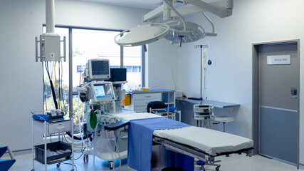 Medical equipment, technology and lighting over operating table in empty hospital operating theatre