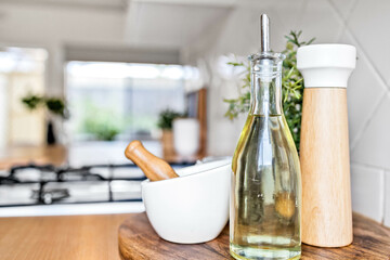 Still life with olive oil, salt grinder and mortar with pestle