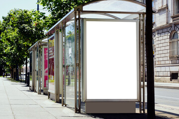 bus shelter at a busstop. glass and steel frame structure. blank white billboard ad display. empty...