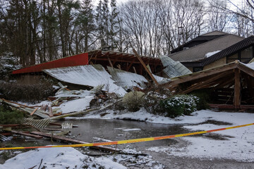 Collapsed roof of an old wooden building. Abandoned architecture, ruins in the countryside.