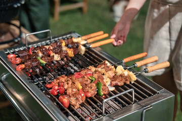 Barbeque skewers meat with vegetable grilling on charcoal bbq grill in backyard