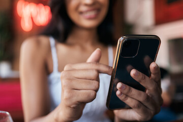 Restaurant, bar and smartphone in hands of woman for social networking, mobile chat app and...
