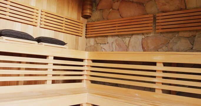 Video of empty wood clad sauna room interior at holiday health spa resort