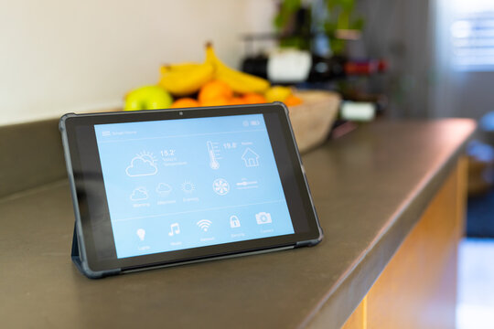Close up of tablet with weather forecast on countertop in kitchen