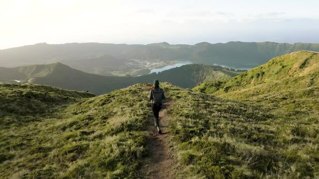 Woman walking towards a panoramic view over the craters and lakes on S&atilde;o Miguel, Azores