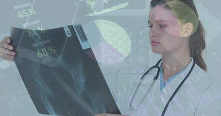 Animation of infographic interface and technology over caucasian female doctor examining x-ray - Powered by Adobe