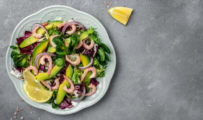 Healthy seafood salad with shrimps, avocado slices and fresh greens, Healthy food. superfood concept. clean eating concept. Vegan or gluten free diet, top view. place for text