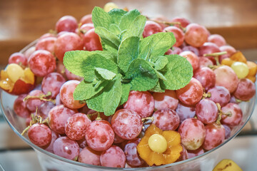 Fruits on the banquet table. Grapes and mint leaves. Holiday.
