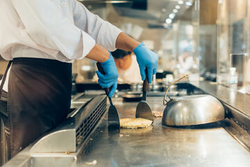 Hand of man take cooking of meat with vegetable grill, Chef cooking wagyu beef in Japanese teppanyaki restaurant