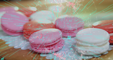 Blue QR code with a red floating web of connections over pink macaronies lying on a table