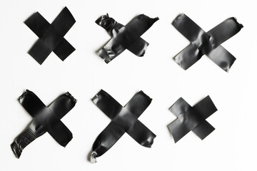 Cross shape black masking tape on white background