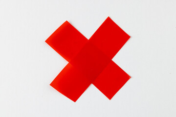 Cross shape red tape with copy space on white background
