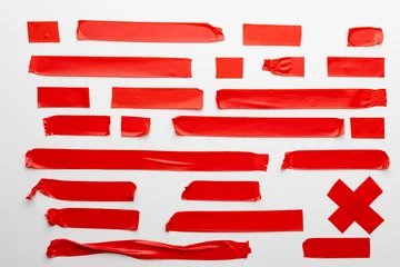 Foto op Canvas Ripped up pieces of red tape with copy space on white background © vectorfusionart