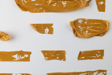 Ripped up pieces of orange tape with copy space on white background