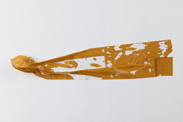 Ripped up pieces of orange tape with copy space on white background