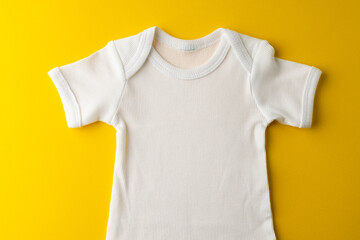 Close up of baby white tshirt on yellow background
