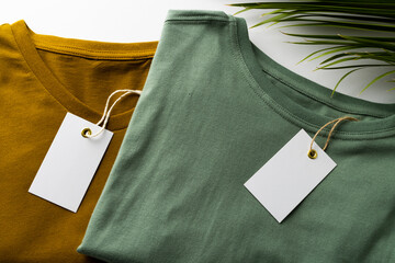Close up of tshirts with tags and copy space on white background
