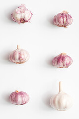 heads of garlic cloves on a light background. pattern
