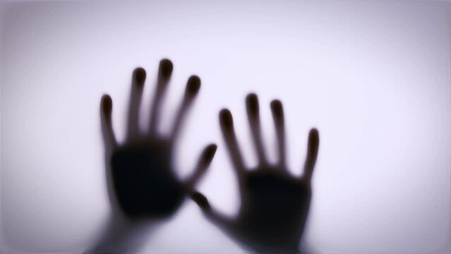 shadows of hands hit the glass. Thriller, horror, violence concept