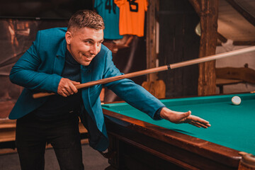 Playing billiards, a man as an amateur plays billiards, a sports board game.