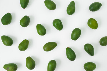 A lot of Avocados on white background. Flat lay, top view. Food concept.