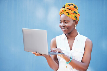 Black woman, laptop and smile for email communication or reading web conversation with blue wall...