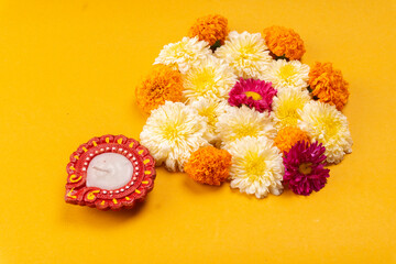 Flower rangoli for Diwali or Pongal made using marigold or zendu flowers and red rose petals. Indian Festival flower decoration.